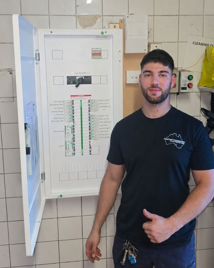 Rami from RNP Electrical beside a new switchboard